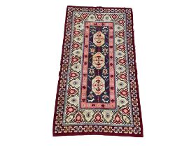 A large vintage Middle Eastern style wool rug. 229x123cm