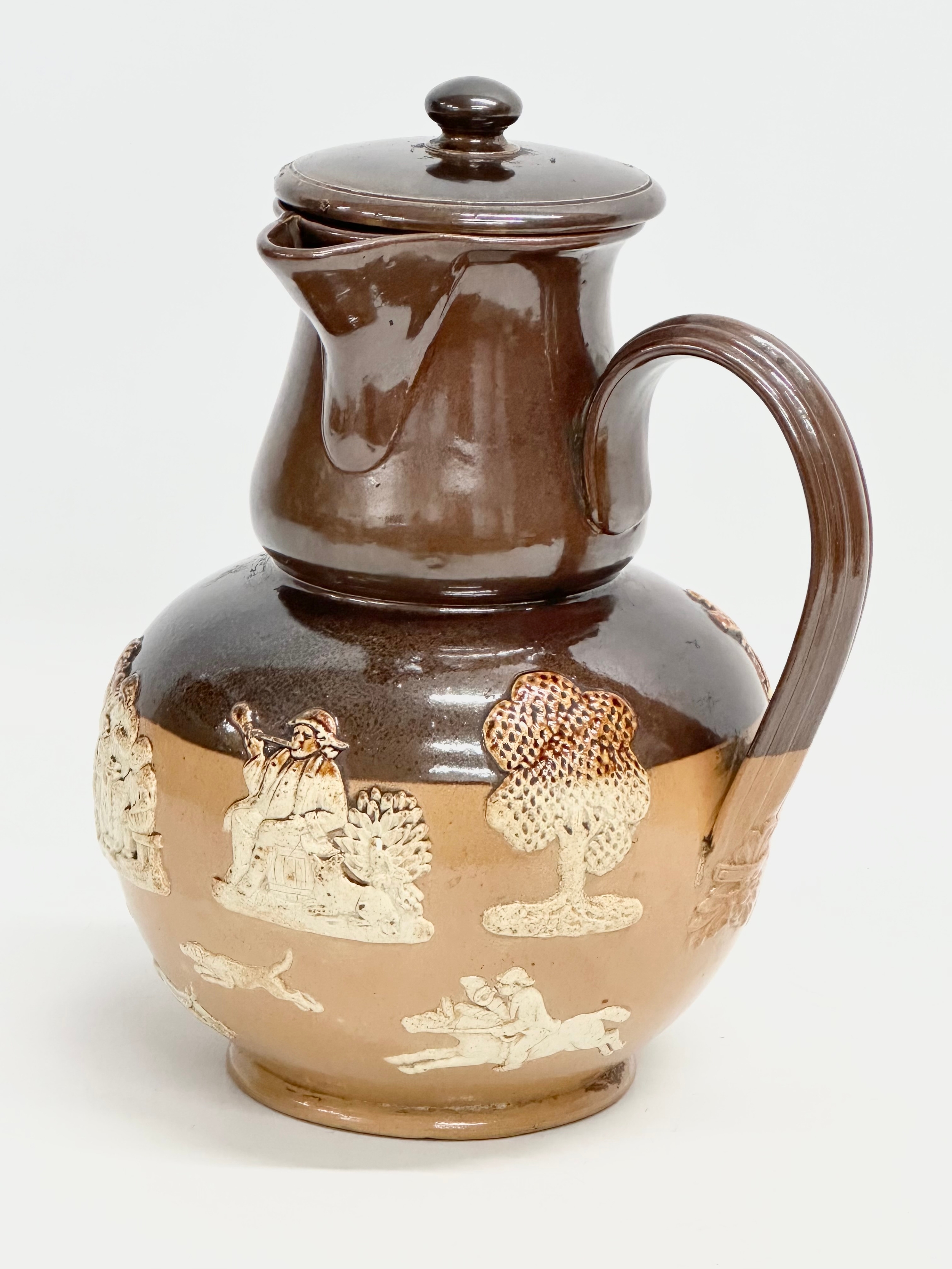 A Royal Doulton Lambeth ‘Harvest’ flagon with spout and sieve. Early 20th century. 17x15x25cm