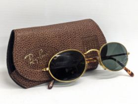 A pair of Ray Ban USA sunglasses with Bausch Lomb lens. John Lennon gold frames. With original case.