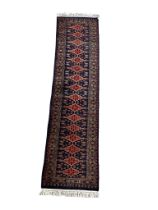 A large vintage hand knotted Kashmir rubber rug. 63x263cm