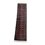 A large vintage hand knotted Kashmir rubber rug. 63x263cm