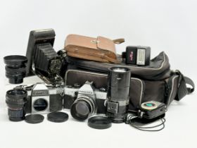 A collection of vintage cameras and lenses. A Praktica MTL 50 camera. A Praktica PL noval camera.