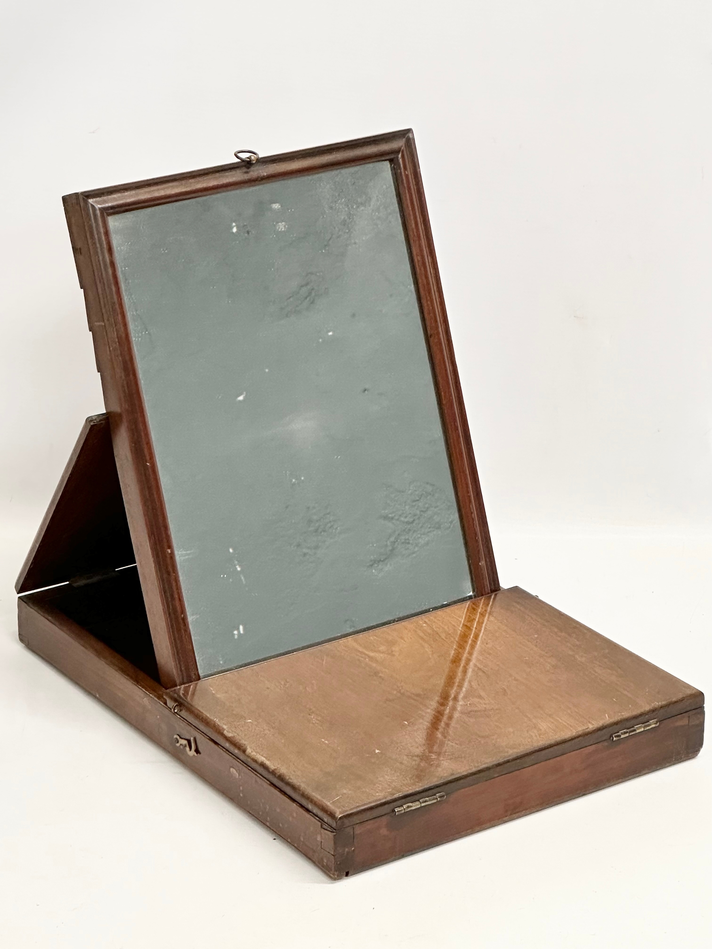 A mid/late 19th century mahogany Campaign mirror. 32x42x37cm open. 41x31x5cm closed.