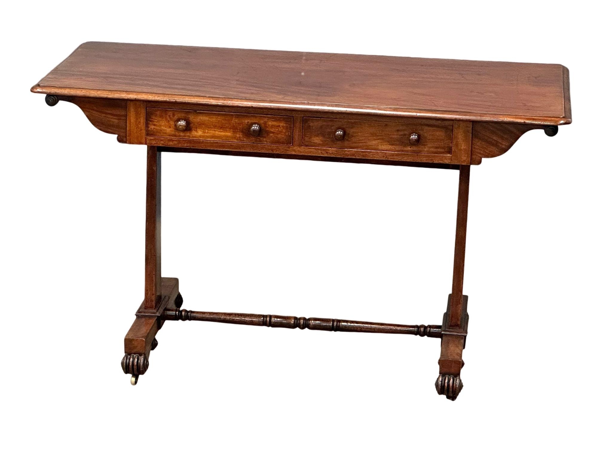 A William IV mahogany double sided library table/sofa table with 2 drawers at front and stretcher