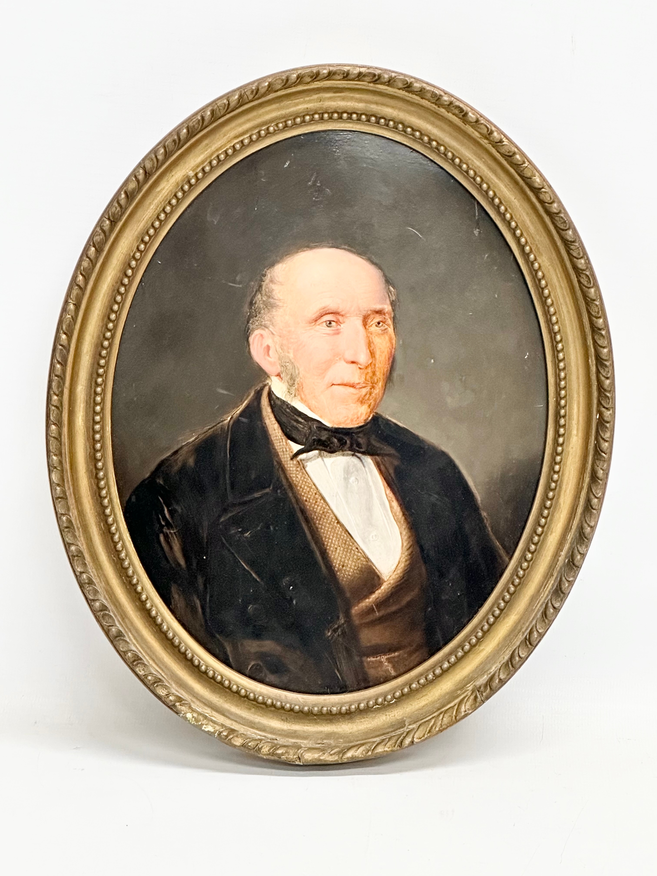 A mid 19th century oil painting on board of a gentleman. In original gilt frame 24x29.5cm