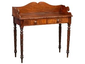 A late George IV mahogany gallery back side table on reeded legs, containing 2 front facing drawers.