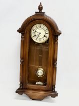 A 19th century style Schmeckenbecker wall clock. With key and pendulum. 63cm