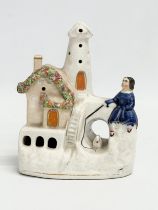 A mid/late 19th century Staffordshire ‘Waiting by the Lighthouse’ figure. 13x16cm