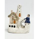 A mid/late 19th century Staffordshire ‘Waiting by the Lighthouse’ figure. 13x16cm