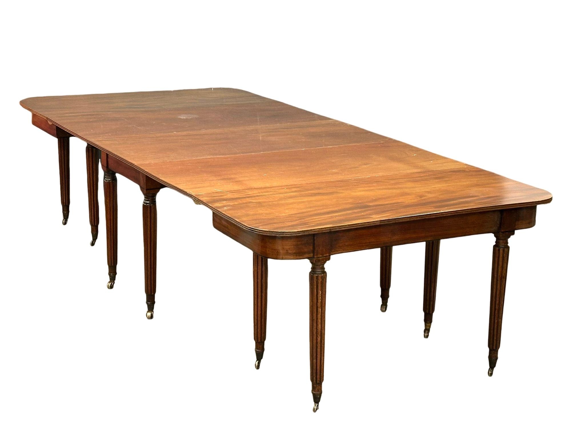 A large George IV mahogany Economy table/dining table with some later alterations. Circa 1820. 307.