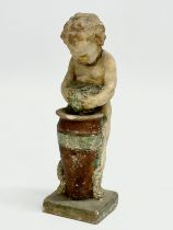 A 19th/early 20th century painted terracotta cherub figurine. Makers mark. 15.5cm