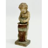 A 19th/early 20th century painted terracotta cherub figurine. Makers mark. 15.5cm