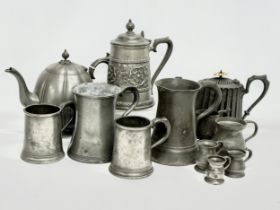 A collection of mid 19th century pewter ware. 2 large Victorian pewter tankards 17x18cm. Pewter