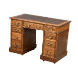 A late Victorian pedestal writing desk with leather top, circa 1890-1900. 106cm x 56cm x 73cm.