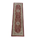 A Middle Eastern style runner rug. 66x230cm