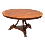 A large Regency style mahogany pedestal dining table with rosewood cross banding and paw feet. 152cm