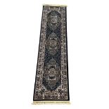 A large Middle Eastern style runner rug. 79x316cm
