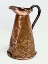 An Art Nouveau copper jug. Circa 1900. 18x24cm