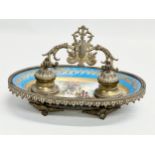 A late 19th century French ornate brass framed inkwell stand with hand painted porcelain bowl.