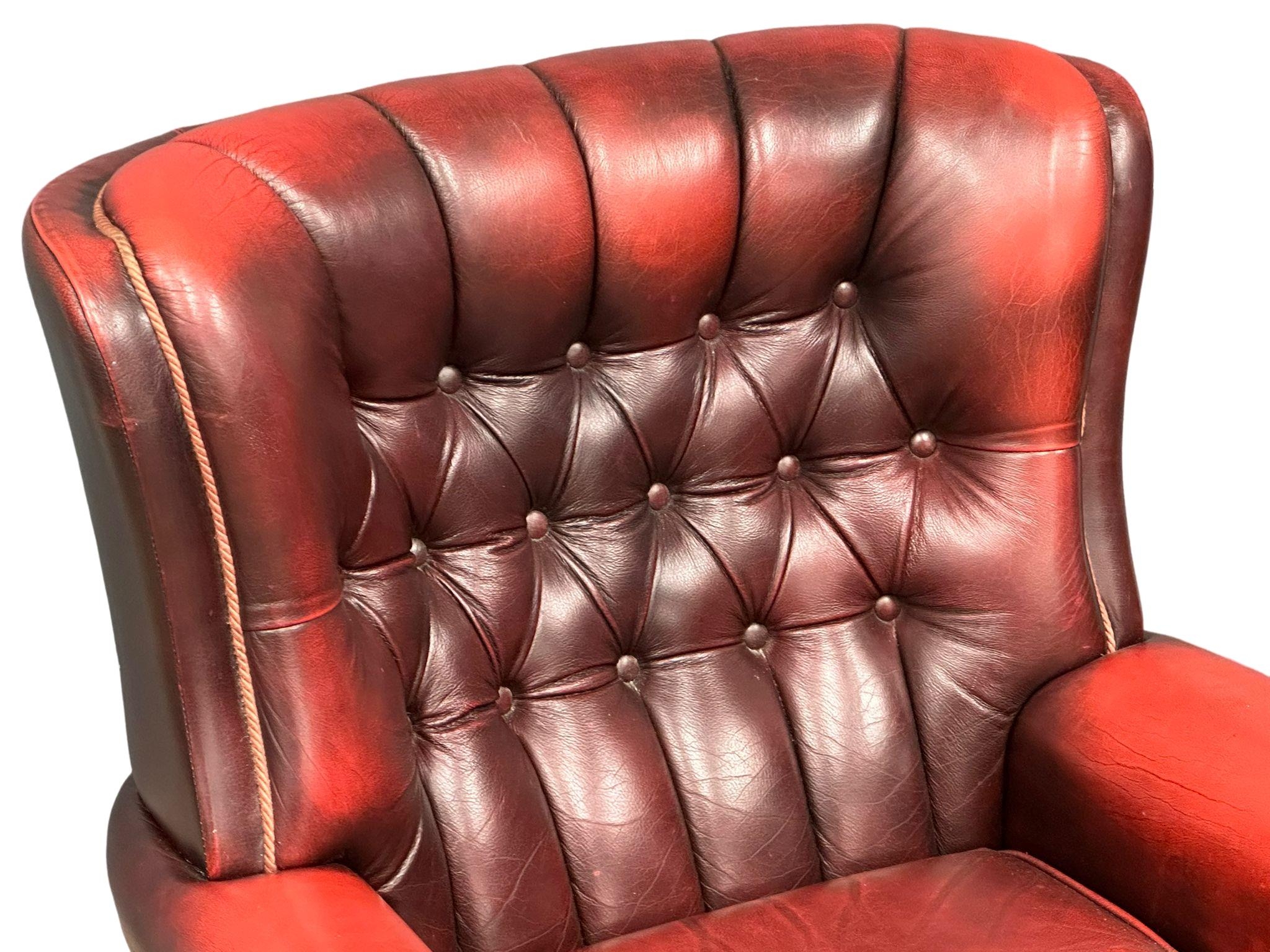 A Victorian style deep buttoned ox blood leather armchair on brass cup casters. 85x75x93cm - Image 2 of 4