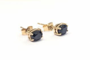 A pair of 9ct gold and sapphire earrings. 0.95g