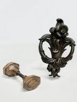 A late 19th century cast iron Art Nouveau door knocker and a Victorian brass door knob. 21cm