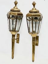 A pair of large early 20th century brass wall lanterns. Circa 1900. 77cm