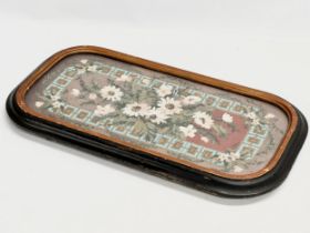 A Victorian lacquered framed tea tray stand with inserted glass and needle work top. 58.5x31x5cm