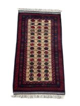 A vintage hand knotted Afghan rug. 104x210cm