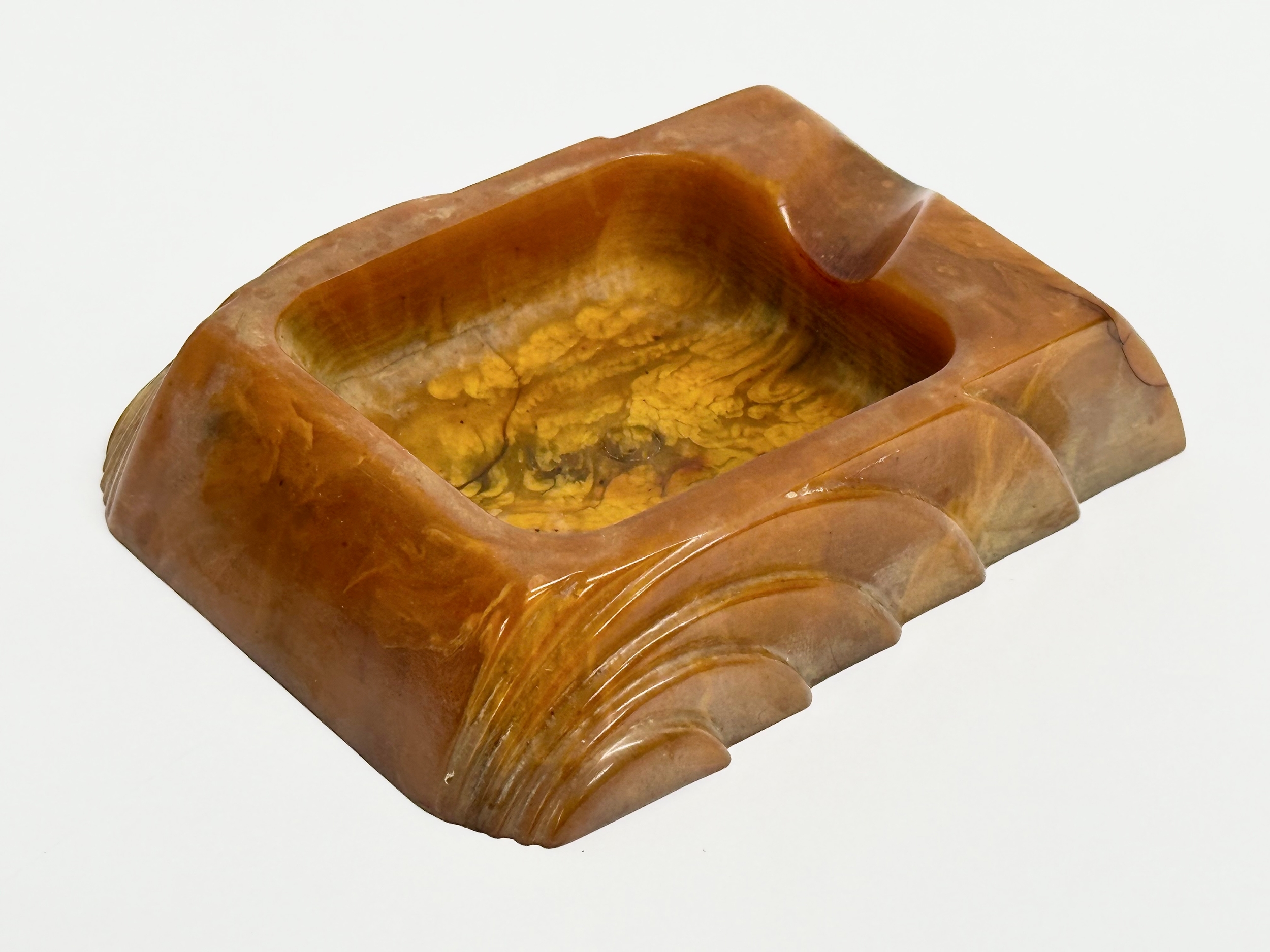 An Art Deco Butterscotch Phenolic Bakelite ashtray by Carvacraft. A Dickenson Product. 8x10cm