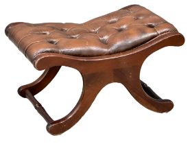 A deep buttoned leather footstool. 69x44x39cm 1