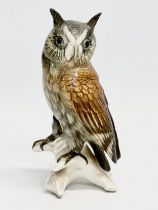 A mid 20th century Karl Ens pottery owl on branch. 17cm.