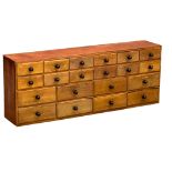 An early 20th Century apothecary bank of drawers, circa 1900, 122.5cm x 24cm x 46.5cm