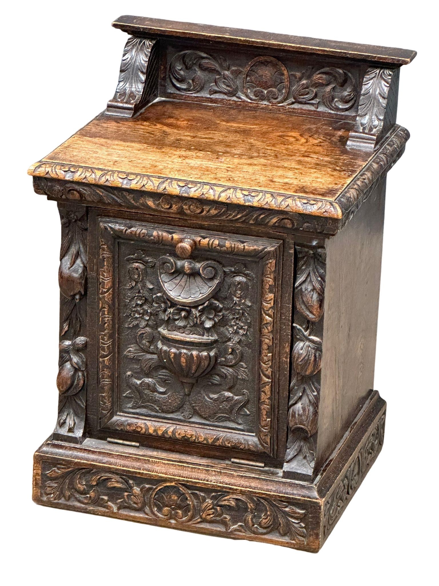 A Victorian carved oak purdonium/coal box. Circa 1870. 47cm x 41cm x 67cm