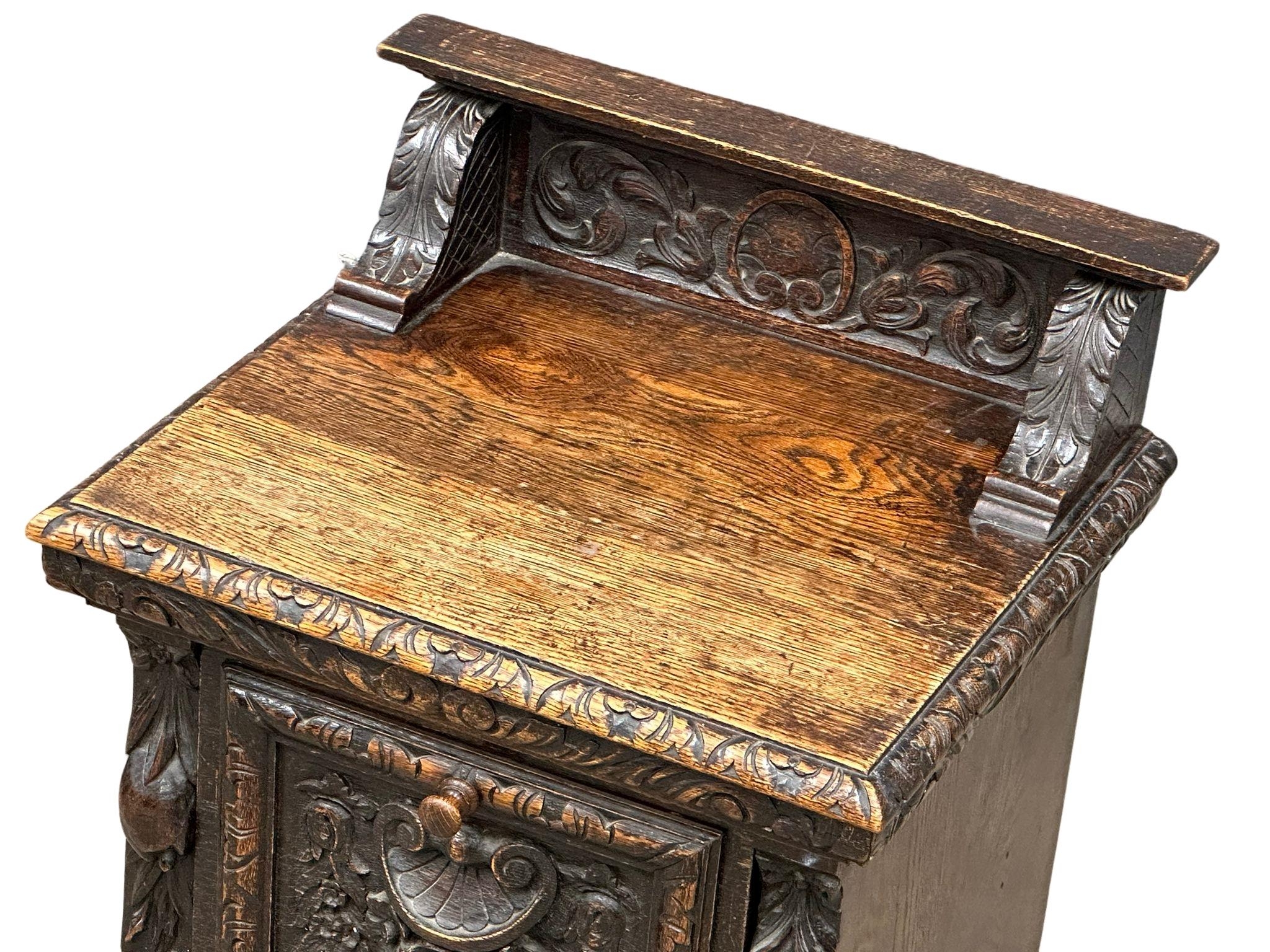 A Victorian carved oak purdonium/coal box. Circa 1870. 47cm x 41cm x 67cm - Image 7 of 7