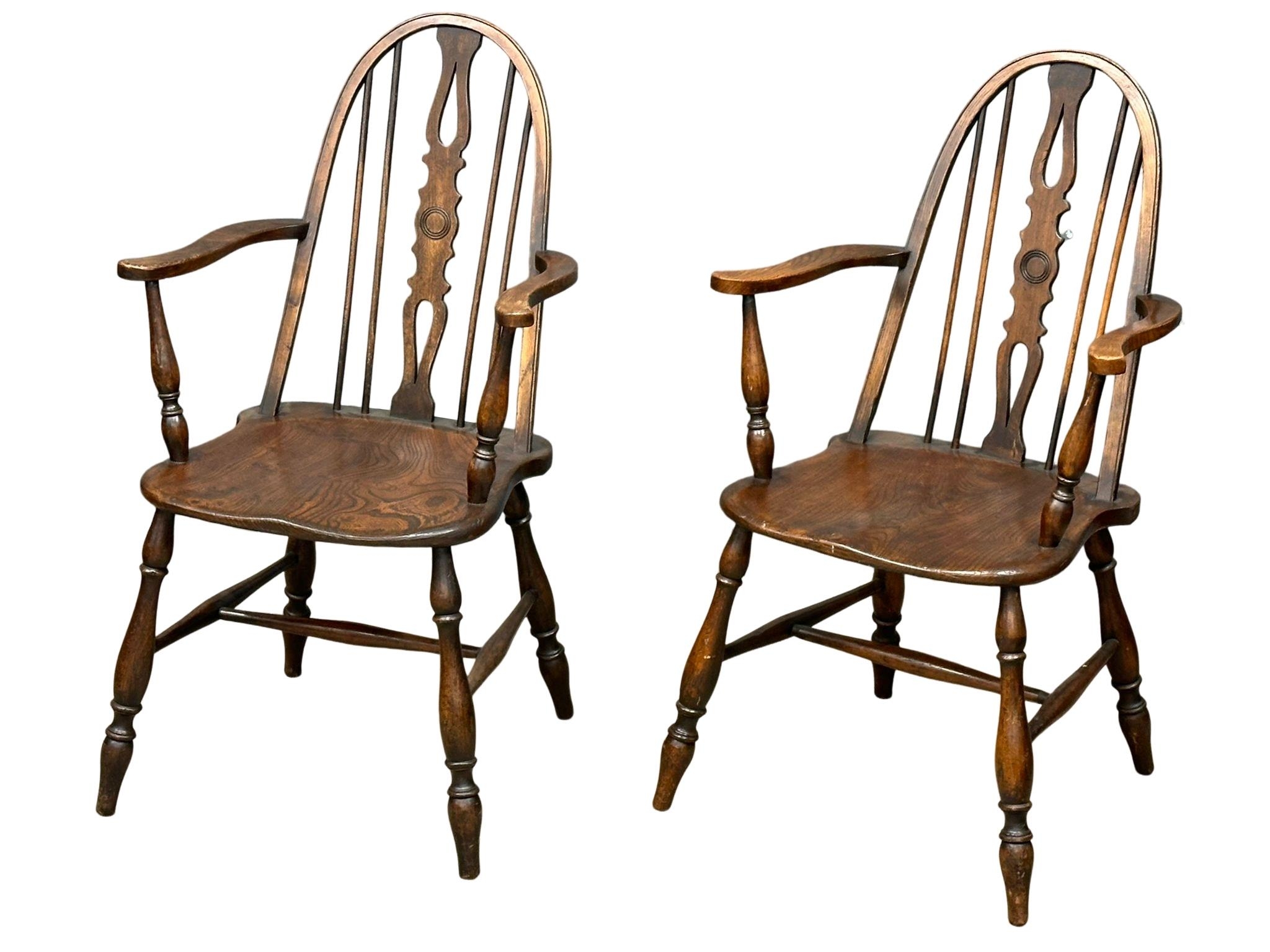 A pair of early 20th Century elm and beech Windsor style armchairs
