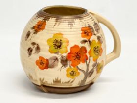 An early 20th century Art Deco jug. In the Clarice Cliff ‘Rhodanthe’ style. 18x14x14cm