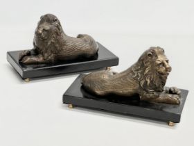 A pair of Bronze Bombay lions on stands, raised on 4 brass feet. 24x12x15cm