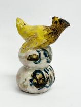 An early 19th century glazed stoneware bird resting on eggs. 9cm