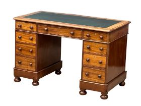 A Victorian pedestal writing desk with leather top and 9 drawers with bun handles. 121x64x77cm