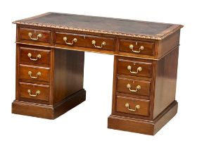 A late Victorian pedestal writing desk with original Greek Key leather top and brass drop handles