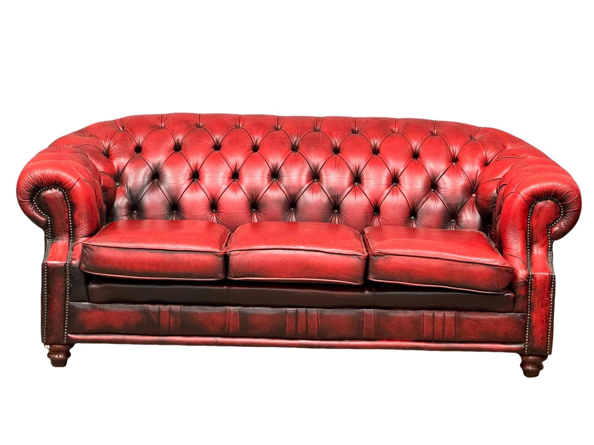 A deep buttoned ox-blood leather Victorian style 3 seater sofa. 207cm