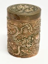 An early 20th century Chinese copper tea caddy stamped Argent. With embossed dragon and phoenix