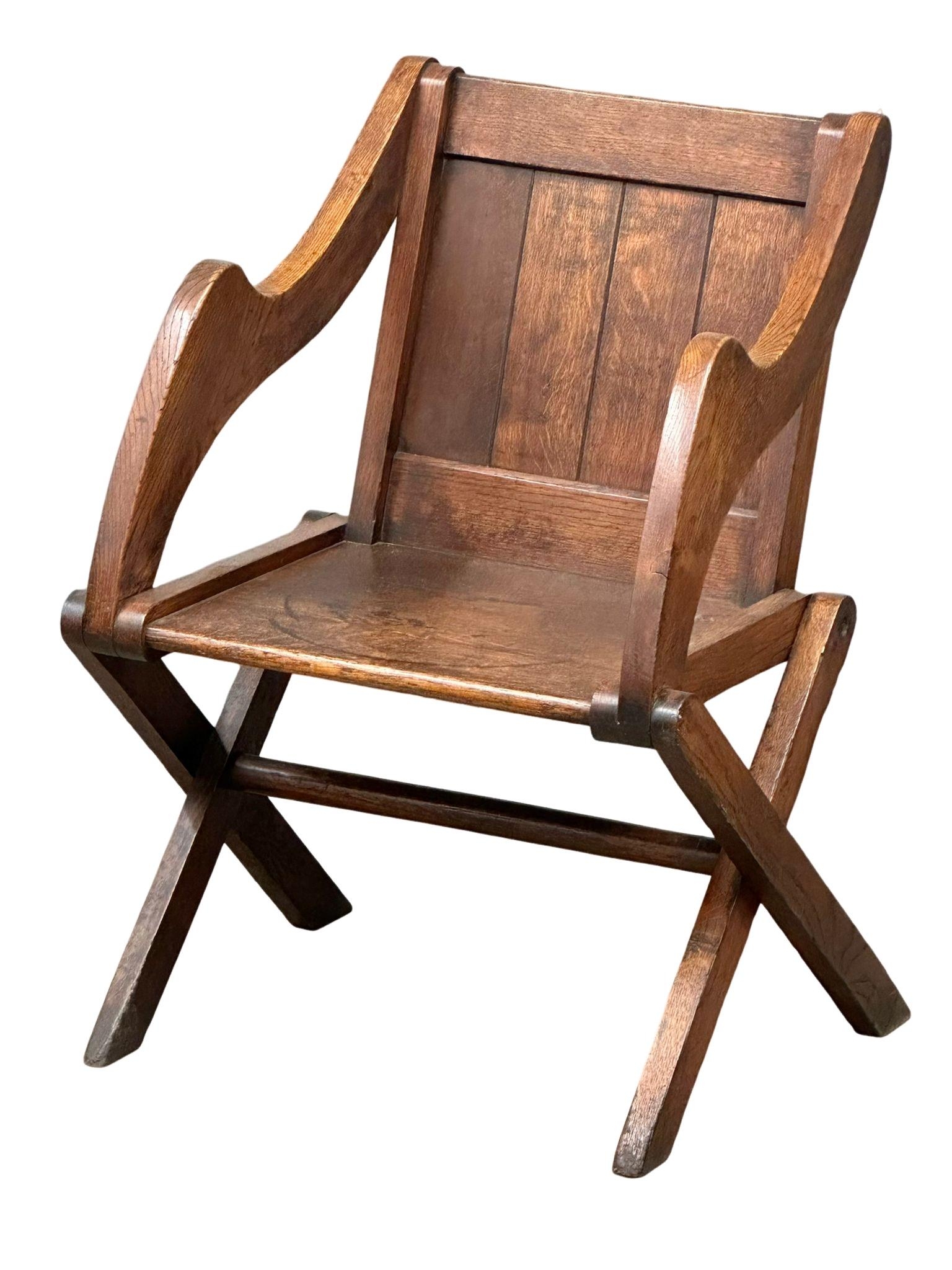 A late 19th century Glastonbury oak armchair. Circa 1890-1900.