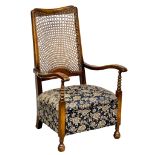 A 1930s fireside armchair with bergere back