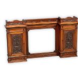 A large late Victorian carved walnut mirror back over-mantle/wall hanging cabinet. Circa 1880.