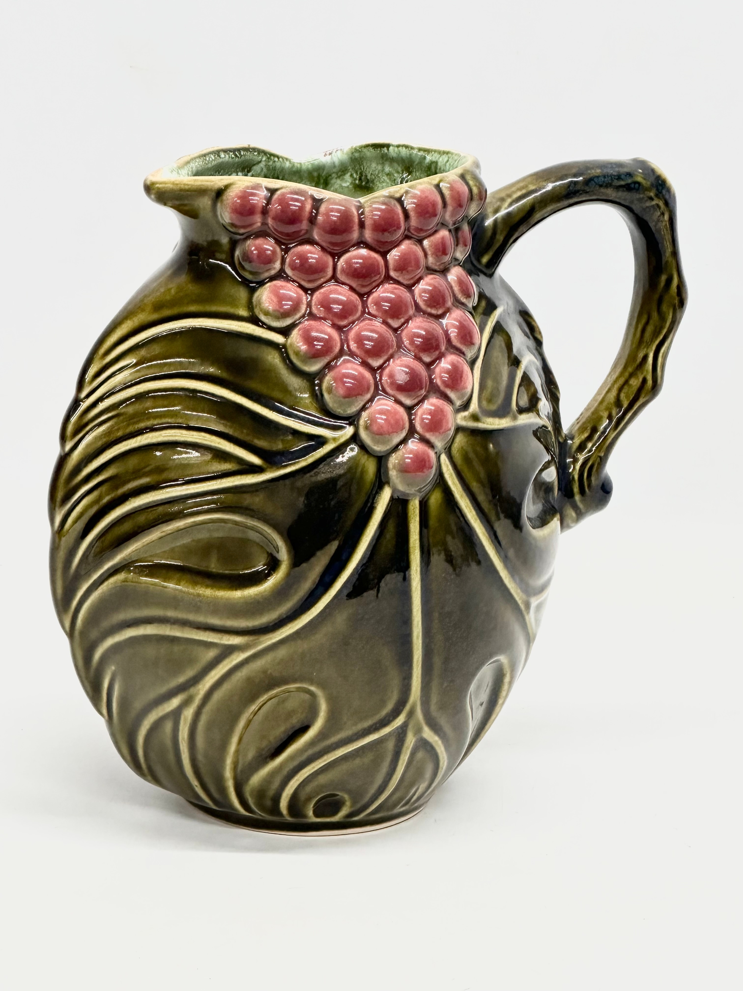A Mid Century West German glazed grape and leaf design jug. 20x20cm
