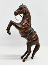 A large early/mid 20th century leather horse. 41cm