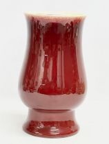 A large 1930’s red glazed pottery baluster vase. 16x27.5cm