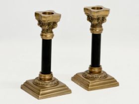 A pair of brass candlesticks with Corinthian column. 16cm